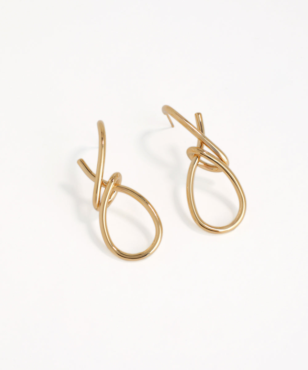 Gold hoop type earrings on a white background