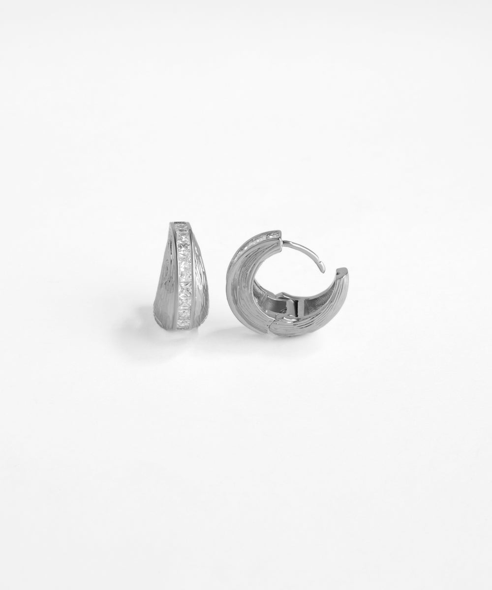 Pair of silver hoop earrings on a white background
