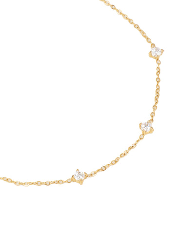 Gold necklace with small diamonds on a white background
