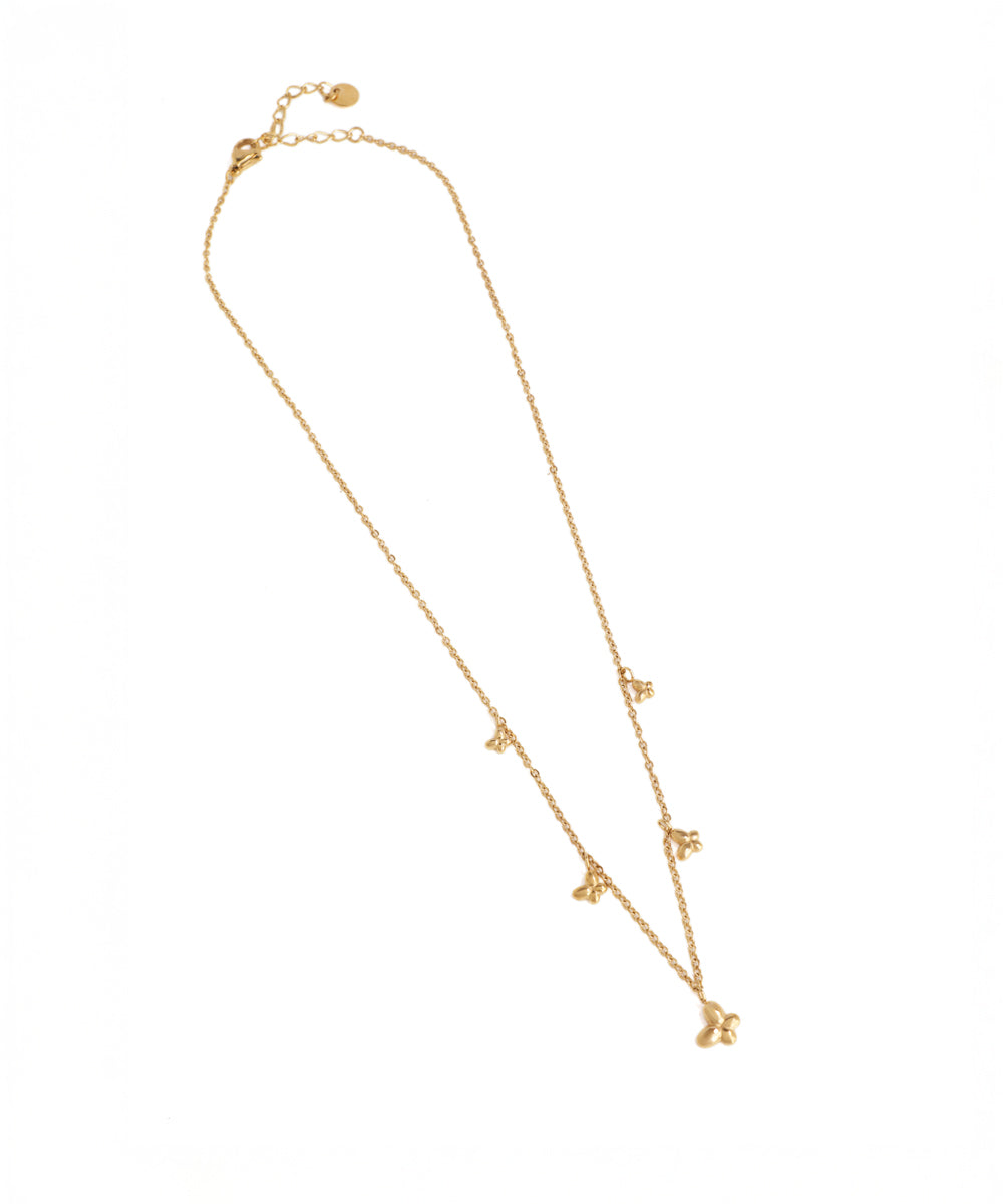 Gold necklace with small pendants on a white background