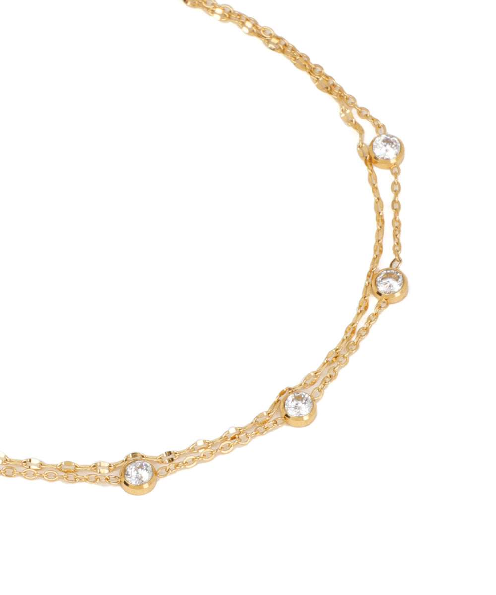 Gold necklace with small diamonds on a white background