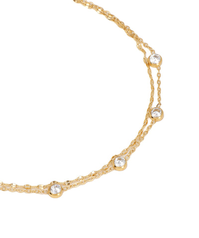 Gold necklace with small diamonds on a white background