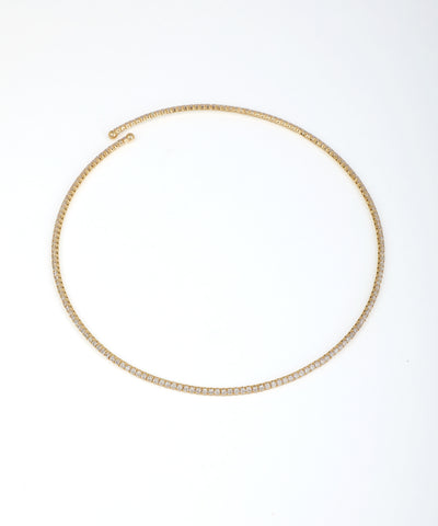 Gold-tone necklace with continuous line of small clear stones in a pave-style setting, open at the back.