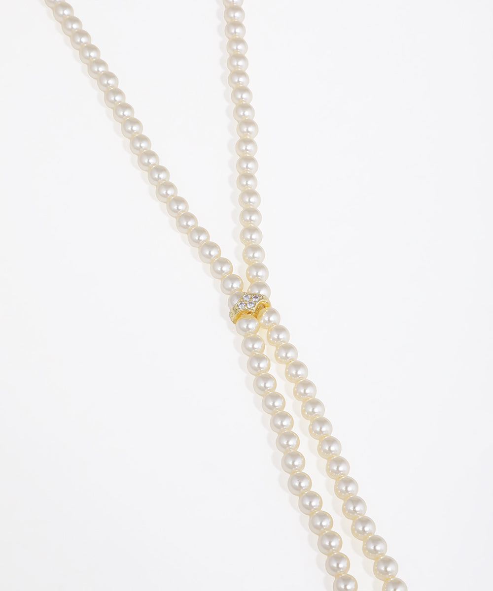 Pearl necklace with a gold clasp on a white background