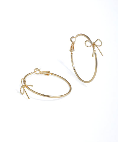Gold hoop earrings with bow details on a white background
