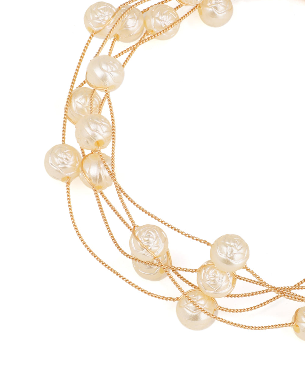 Necklace with pearls and gold chains on a white background