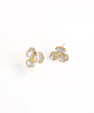 Gold and pearl flower-shaped earrings on a white background