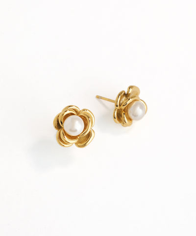 Gold flower-shaped earrings with pearl centers on a white background