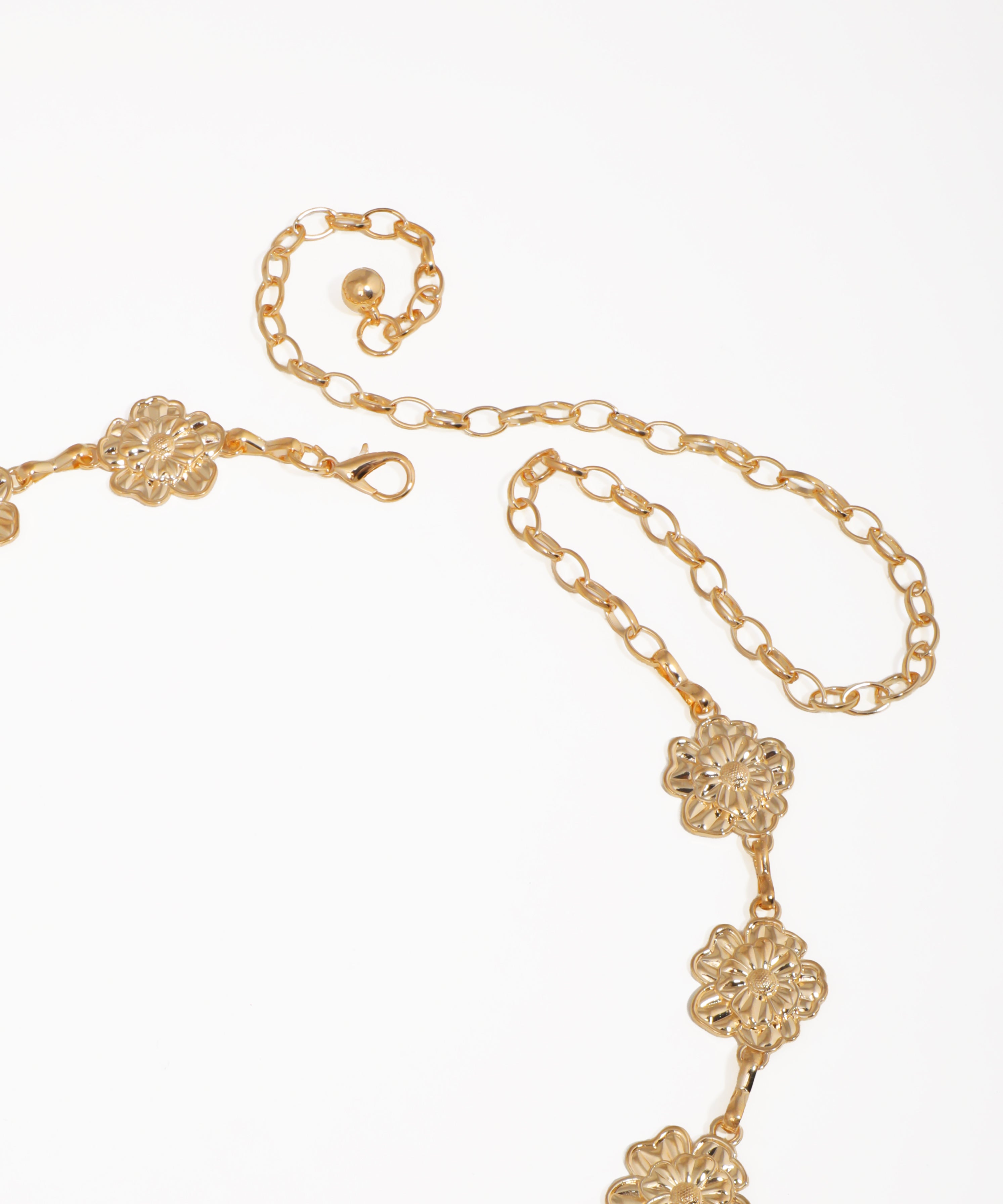 Gold necklace with floral designs on a white background