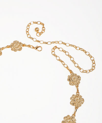 Gold necklace with floral designs on a white background
