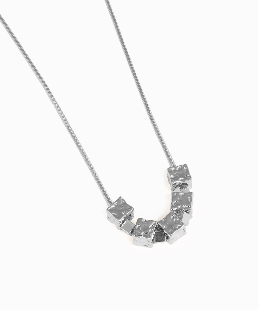 Necklace with a geometric pendant on a white background