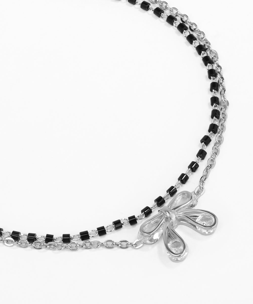 Silver and black beaded bracelet with a decorative clasp on a white background