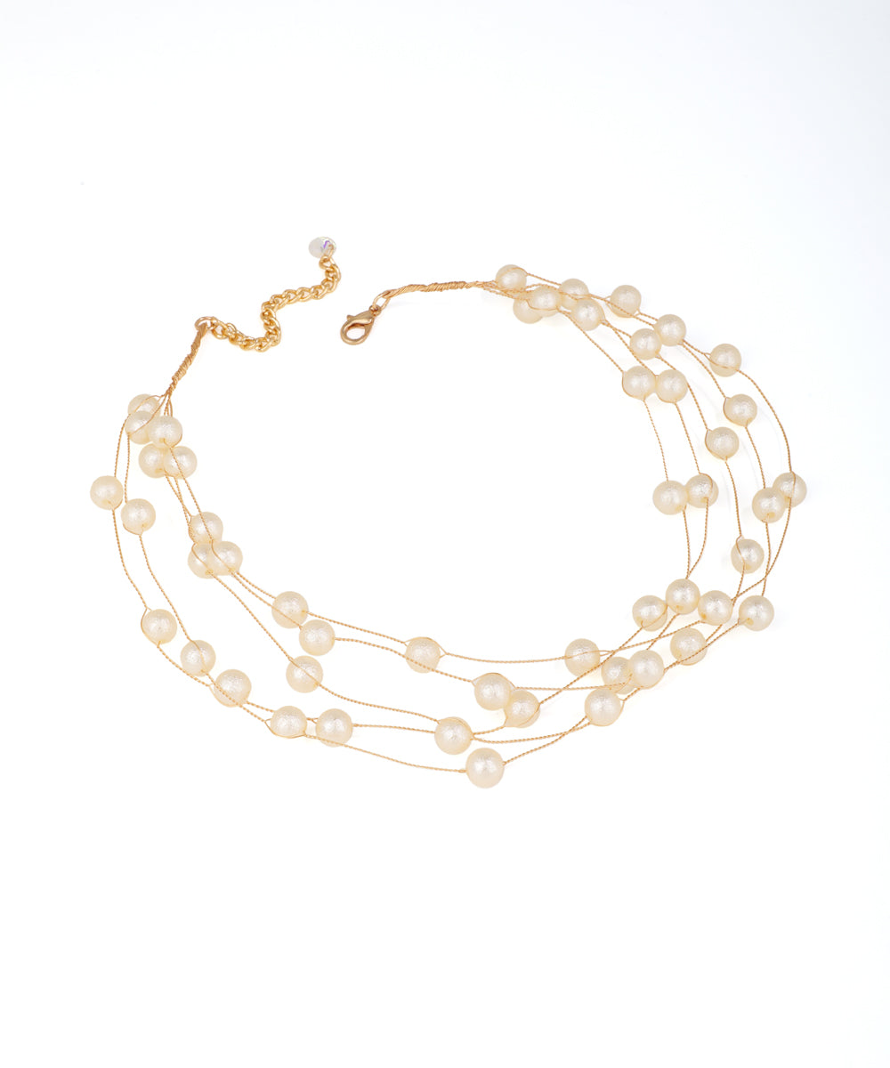 Gold-tone multi-strand necklace with spaced faux pearls on delicate wires