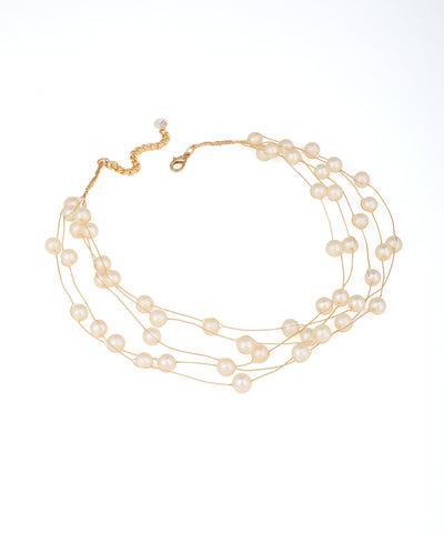 Gold-tone multi-strand necklace with spaced faux pearls on delicate wires