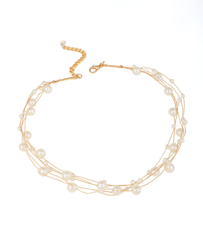 Gold-tone necklace with multiple delicate strands and scattered faux pearls