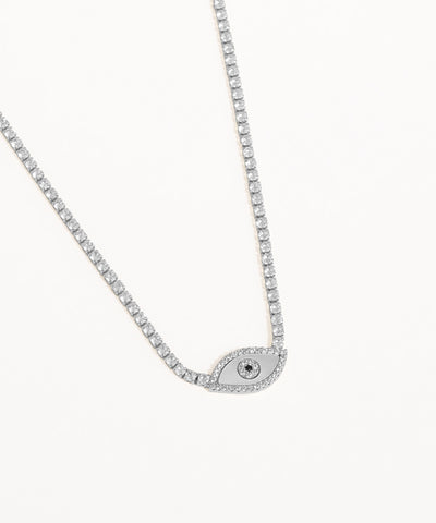 Silver necklace with a small evil eye pendant on a white background
