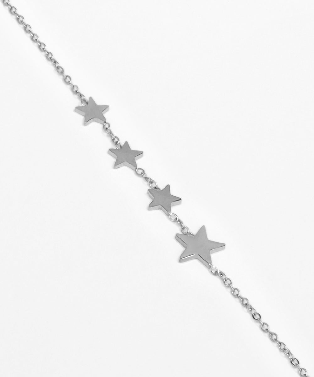 Silver star necklace on a white background