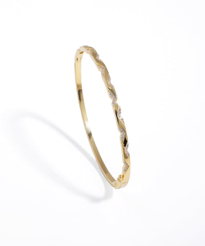 Gold-tone bracelet with a twisted design and clear sparkling stones