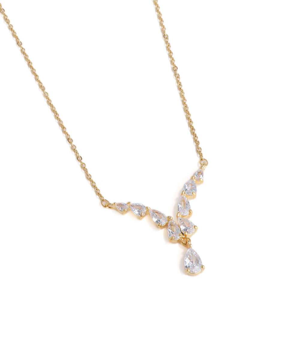 Gold necklace with teardrop-shaped crystals on a white background