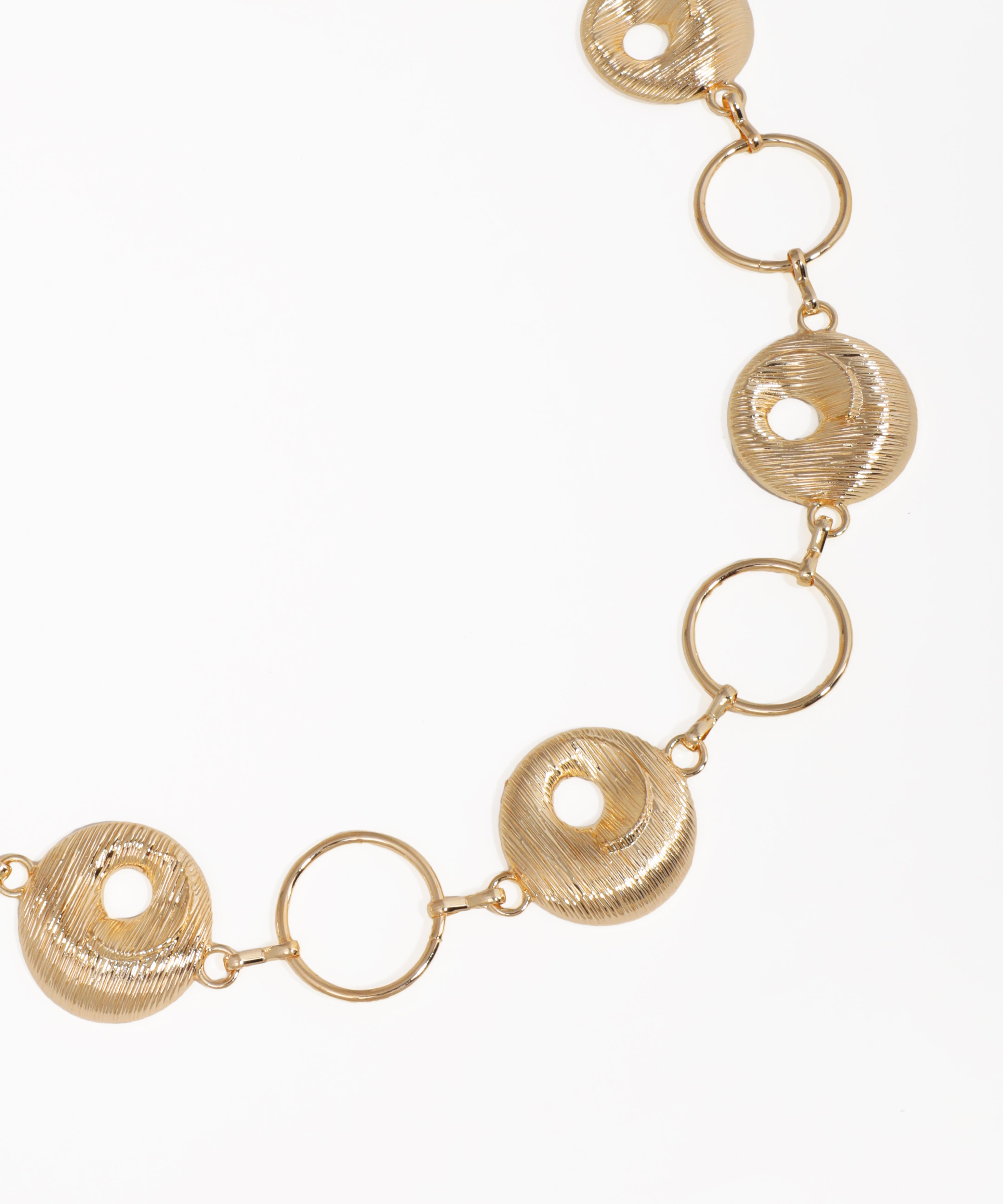 Gold necklace with circular links on a white background