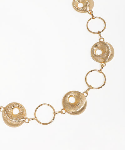Gold necklace with circular links on a white background