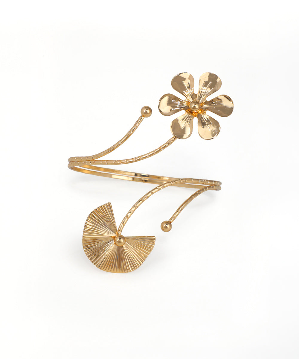 Gold bracelet with a floral design on a white background