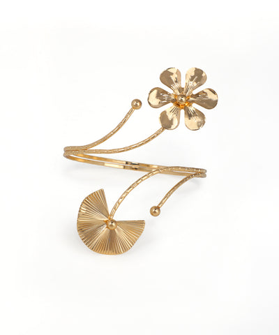 Gold bracelet with a floral design on a white background