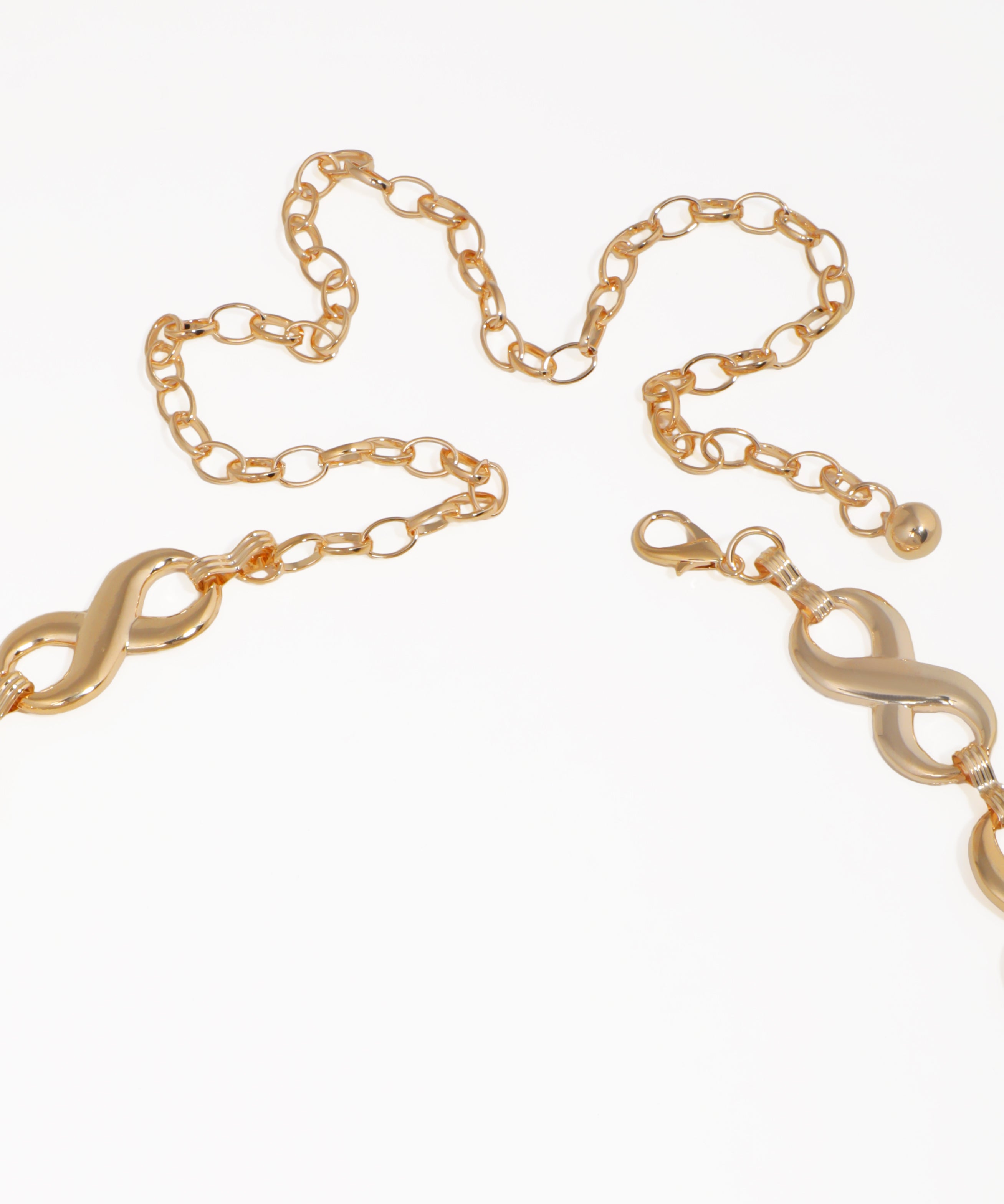 Gold chain with infinity symbol on a white background