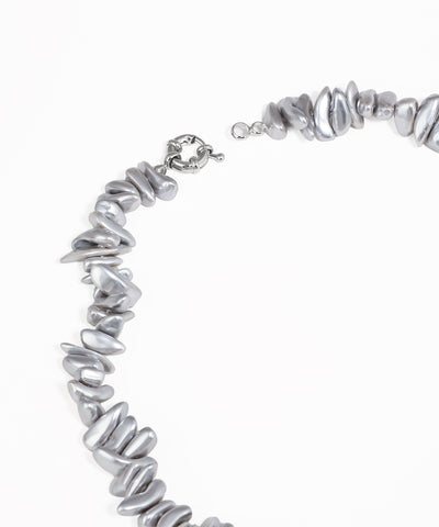 Silver beaded necklace on a white background