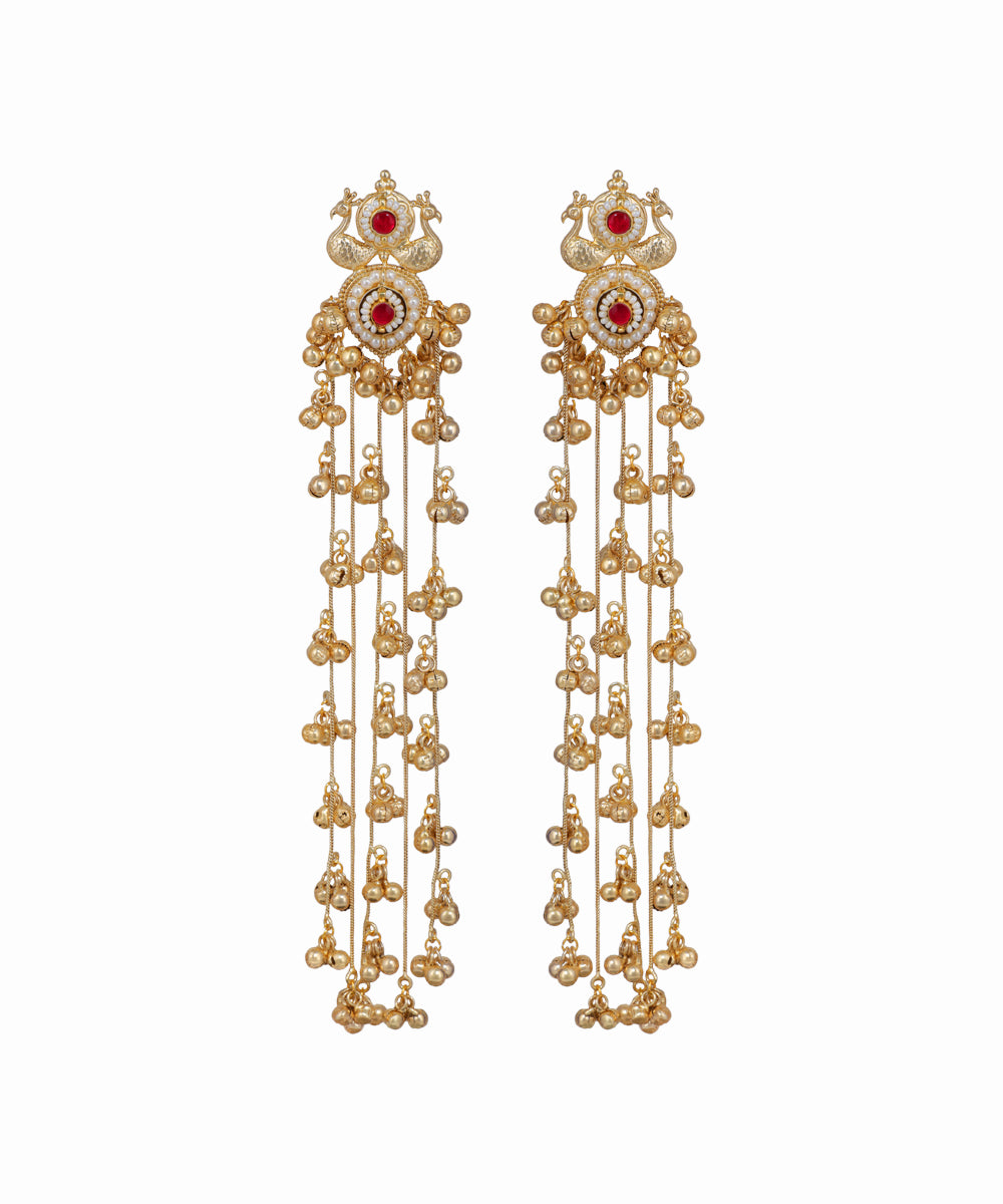 Pair of gold earrings with red gemstones on a white background