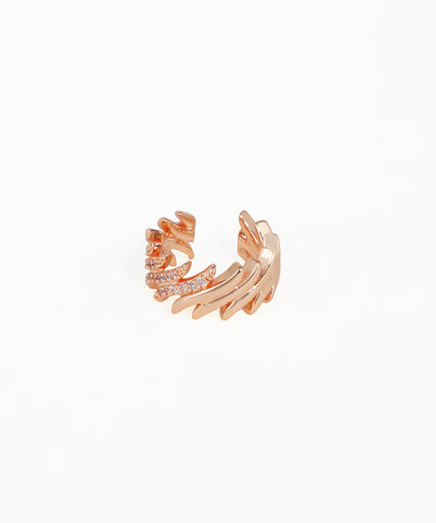 Rose gold ear cuff with intricate design on a white background