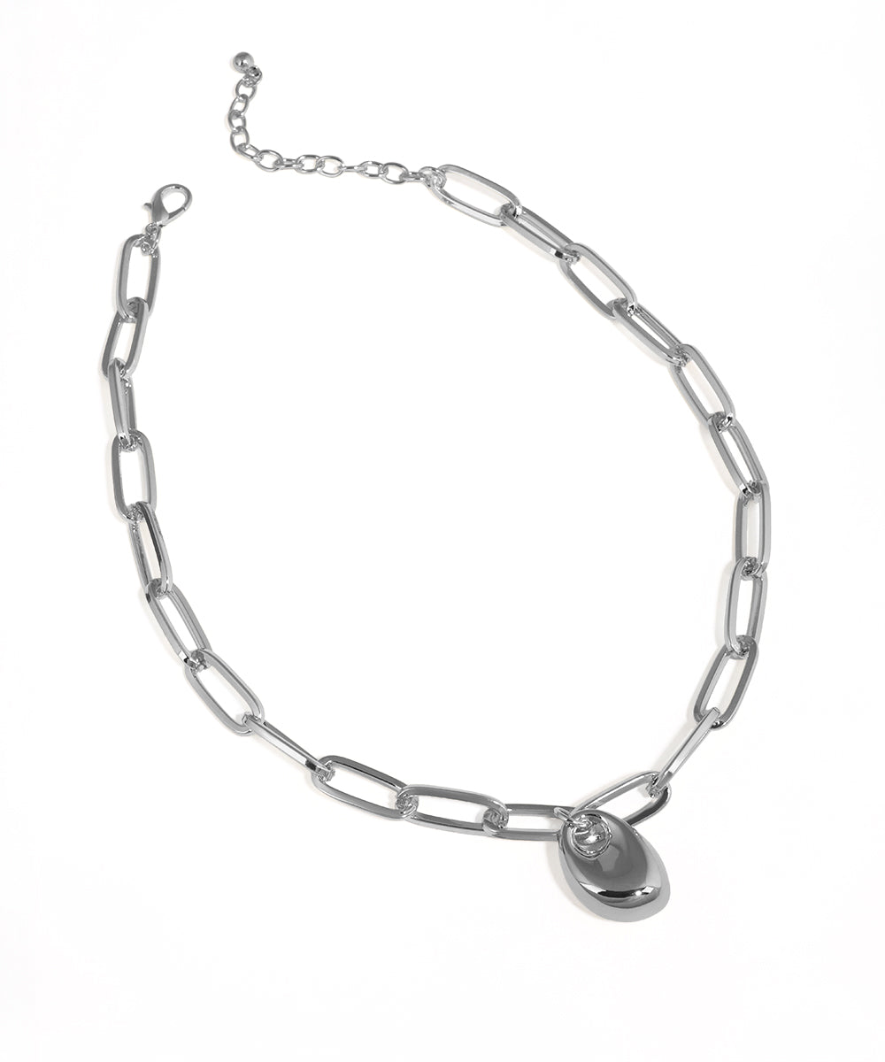 Silver-tone necklace with chunky oval links and a polished abstract drop pendant