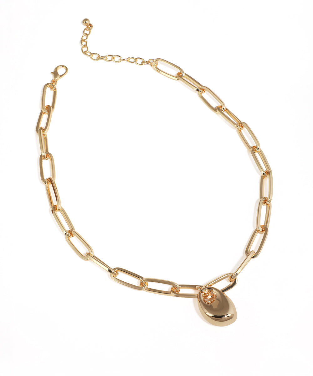 Gold chain necklace with a teardrop pendant on a white background
