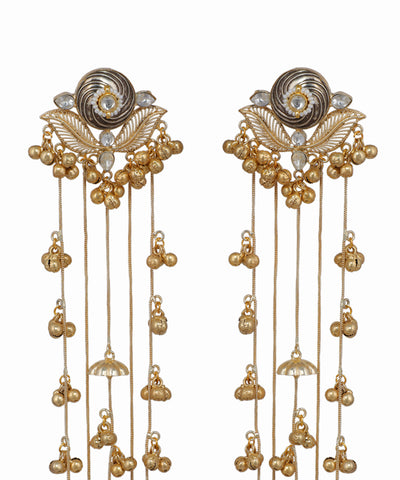 Pair of gold and silver earrings with intricate designs on a white background