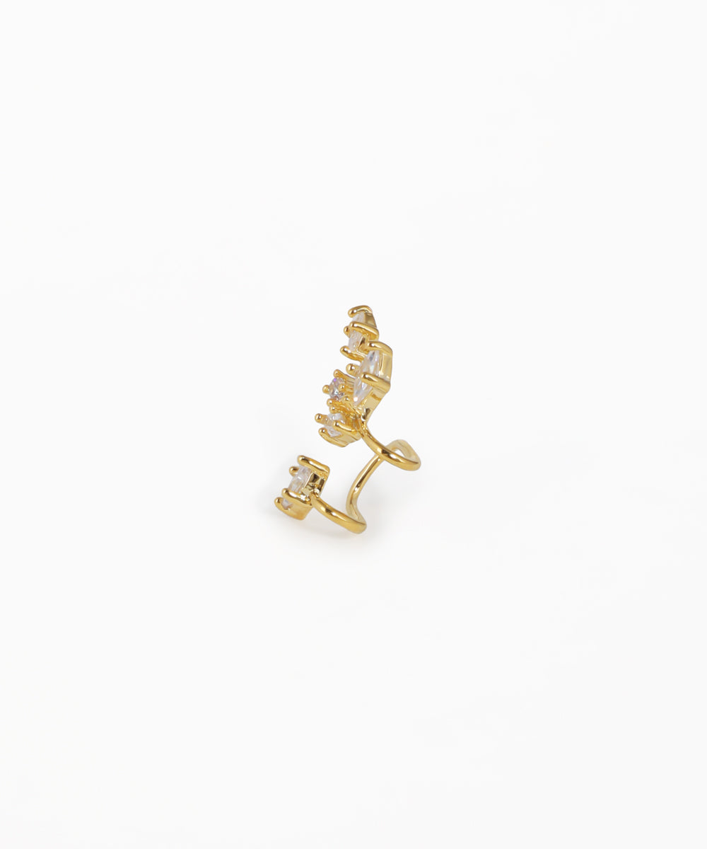 Gold ear cuff with small diamonds on a white background