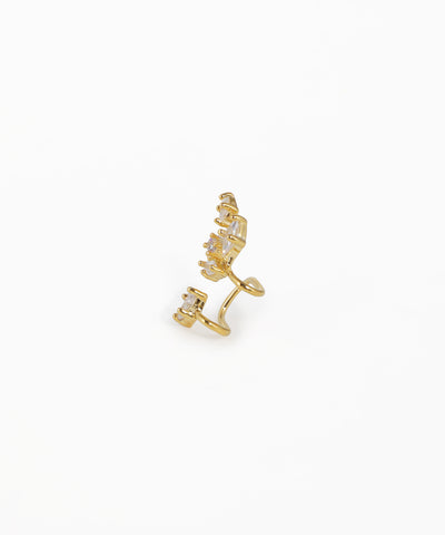 Gold ear cuff with small diamonds on a white background