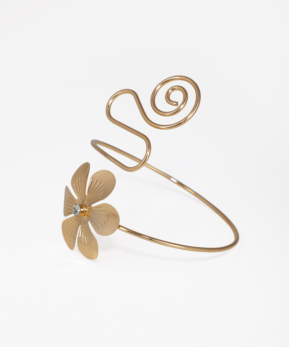Gold-tone arm cuff with a floral design and a top spiral detail.