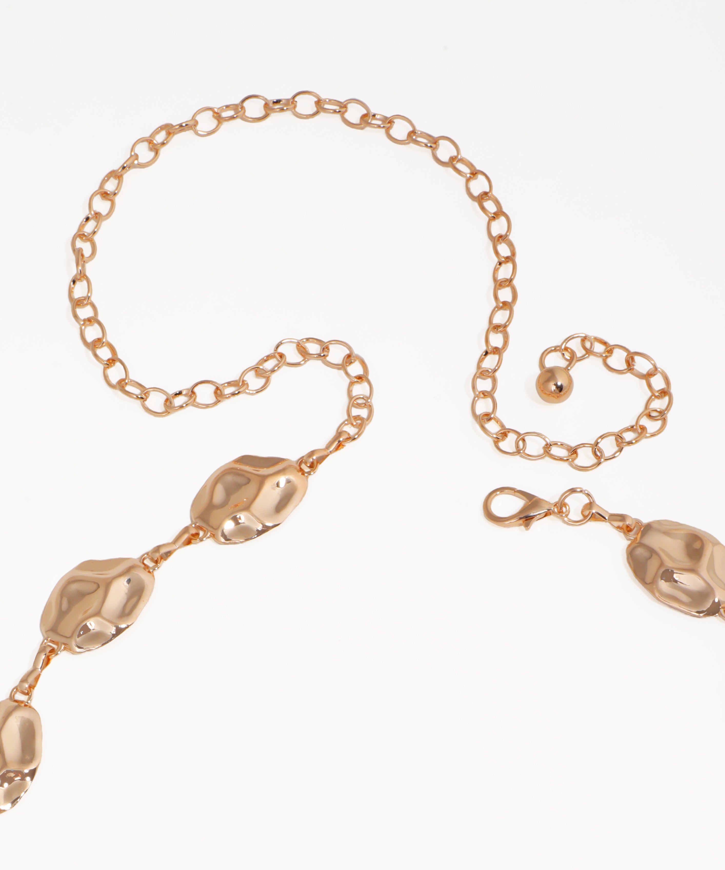 Gold bracelet with decorative elements on a white background