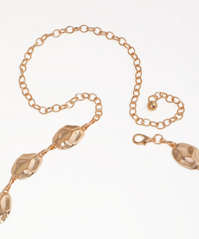 Gold bracelet with decorative elements on a white background