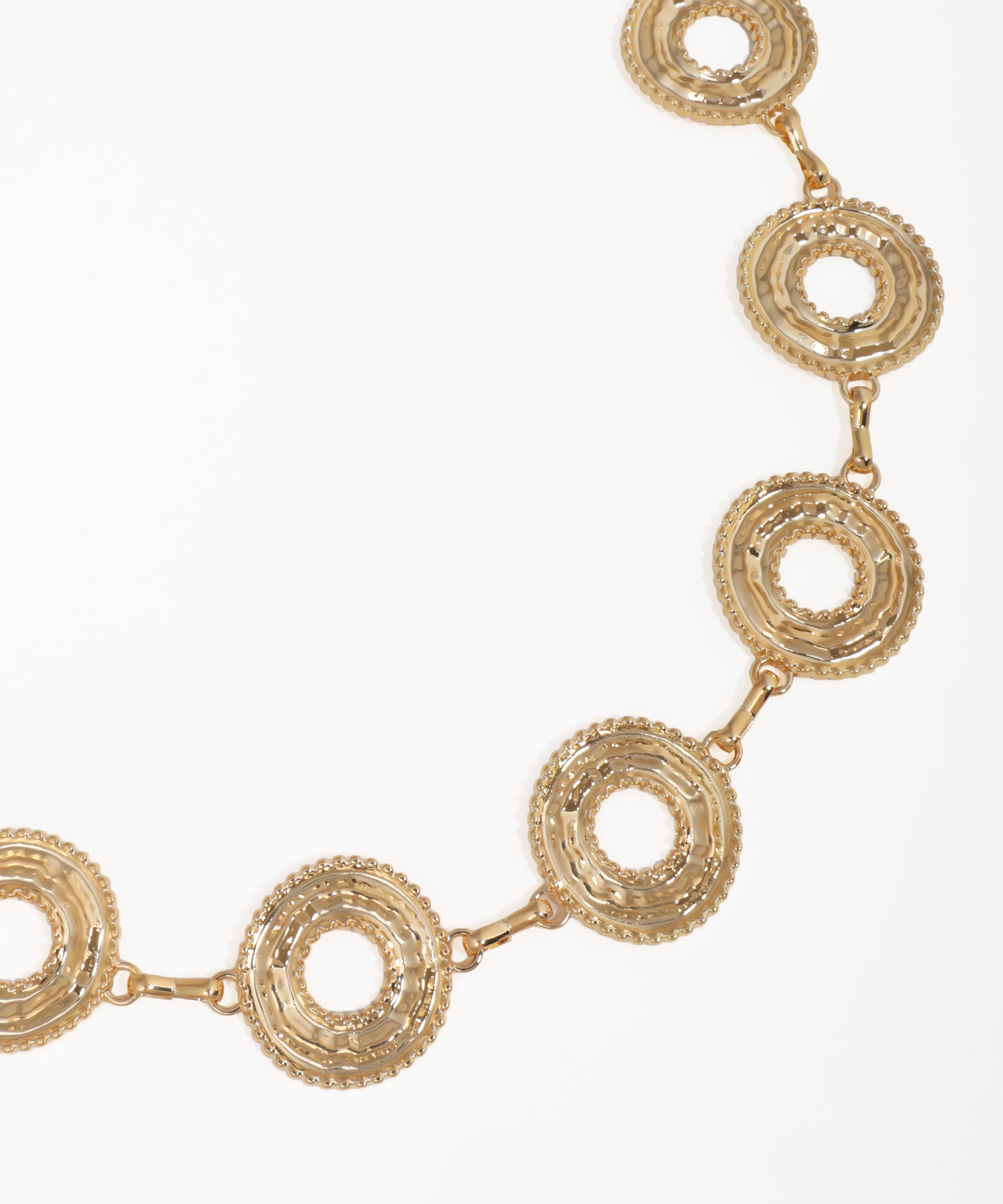 Gold necklace with circular links on a white background