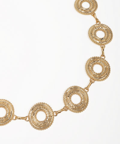 Gold necklace with circular links on a white background