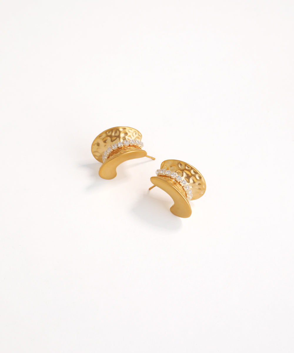 Gold earrings with intricate designs on a white background