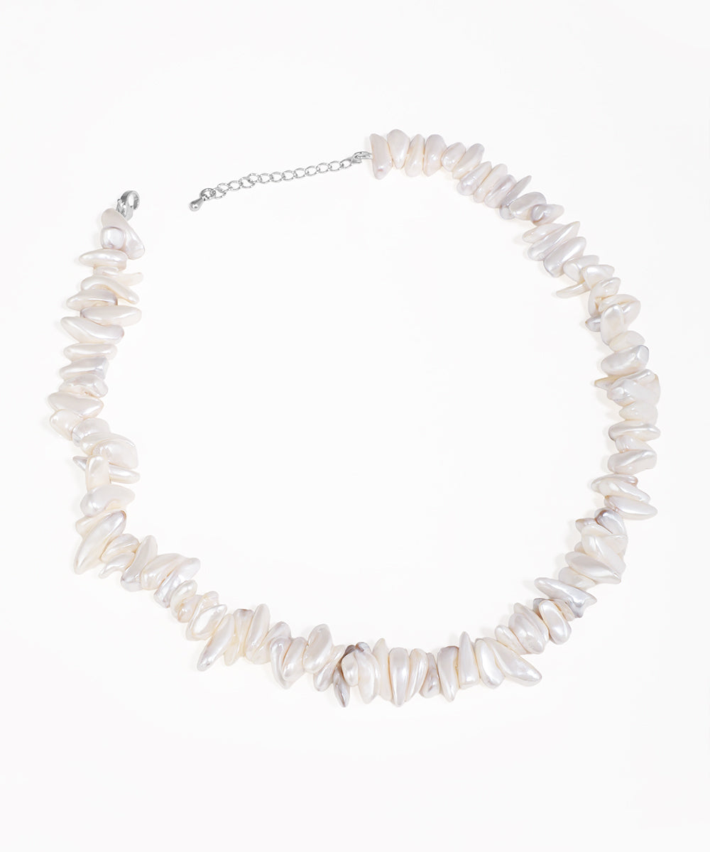 Silver-tone necklace with irregular white chip beads and an extender chain