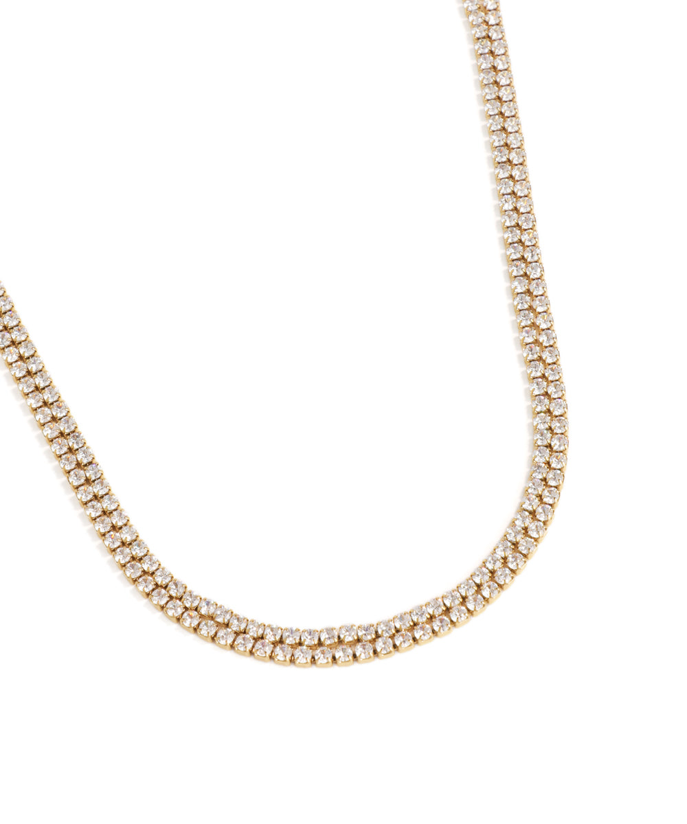 Gold necklace with clear stones on a white background