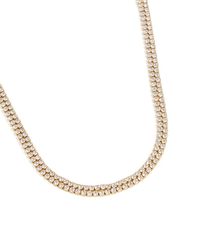 Gold necklace with clear stones on a white background
