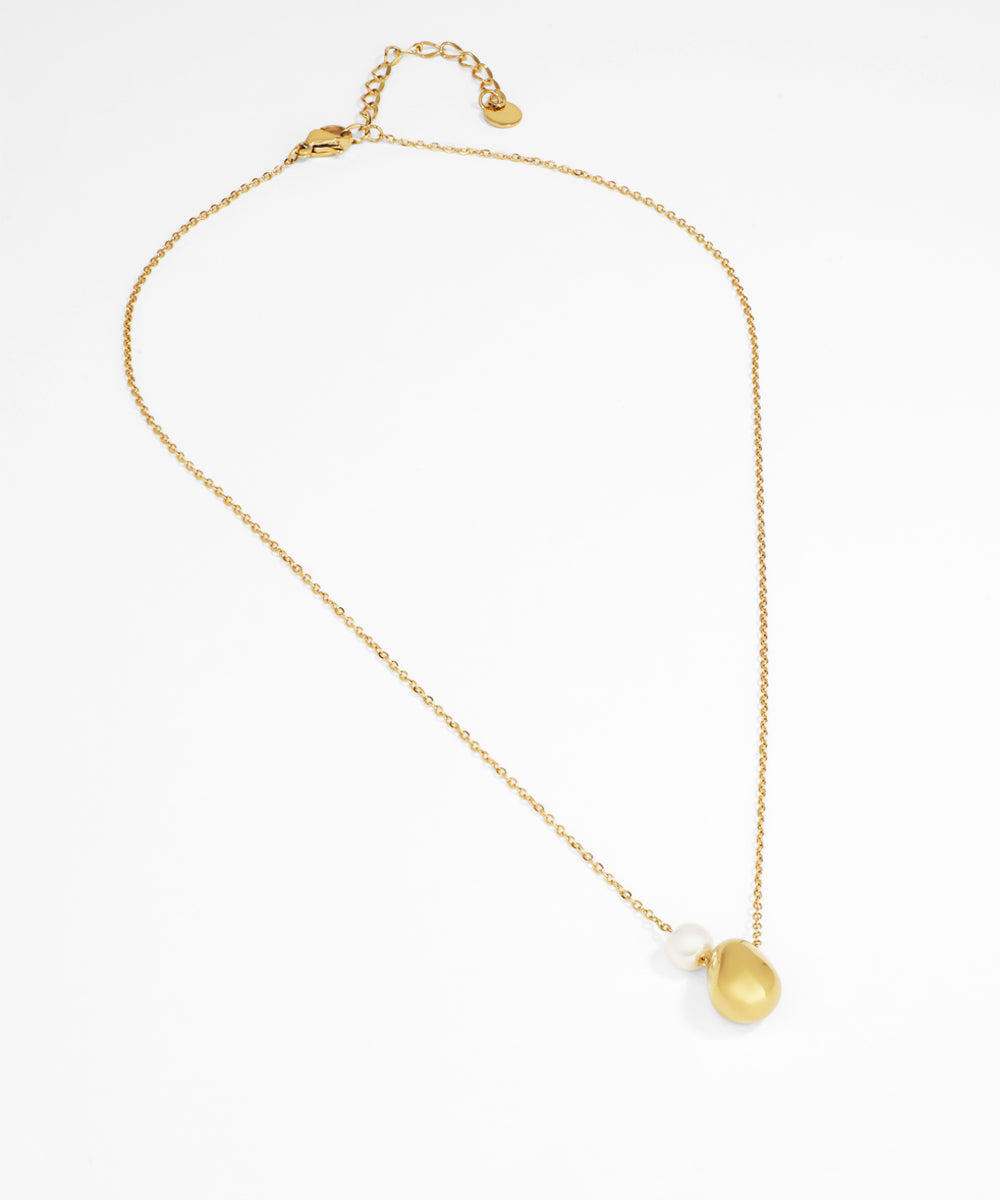 Gold necklace with a teardrop pendant on a white background