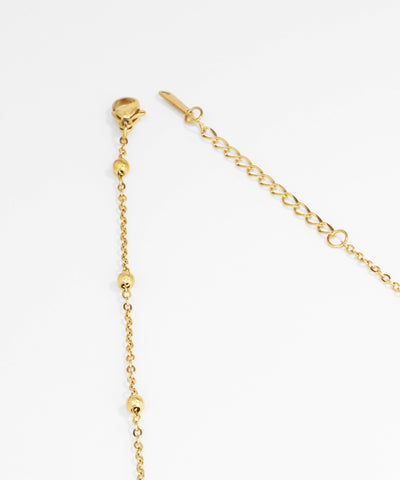 Gold chain necklace on a white background