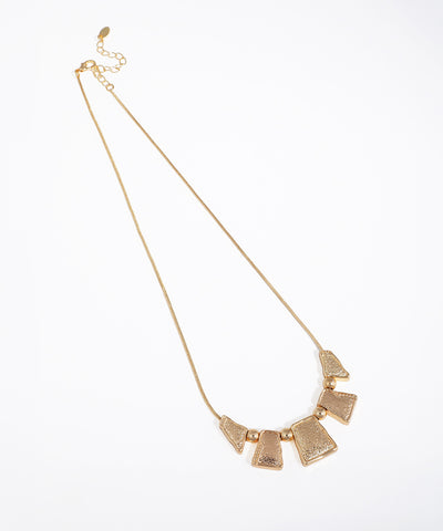 Gold-tone necklace with hammered geometric segments and round beads on a snake chain