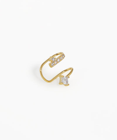 Gold open ring with clear gemstones on a white background