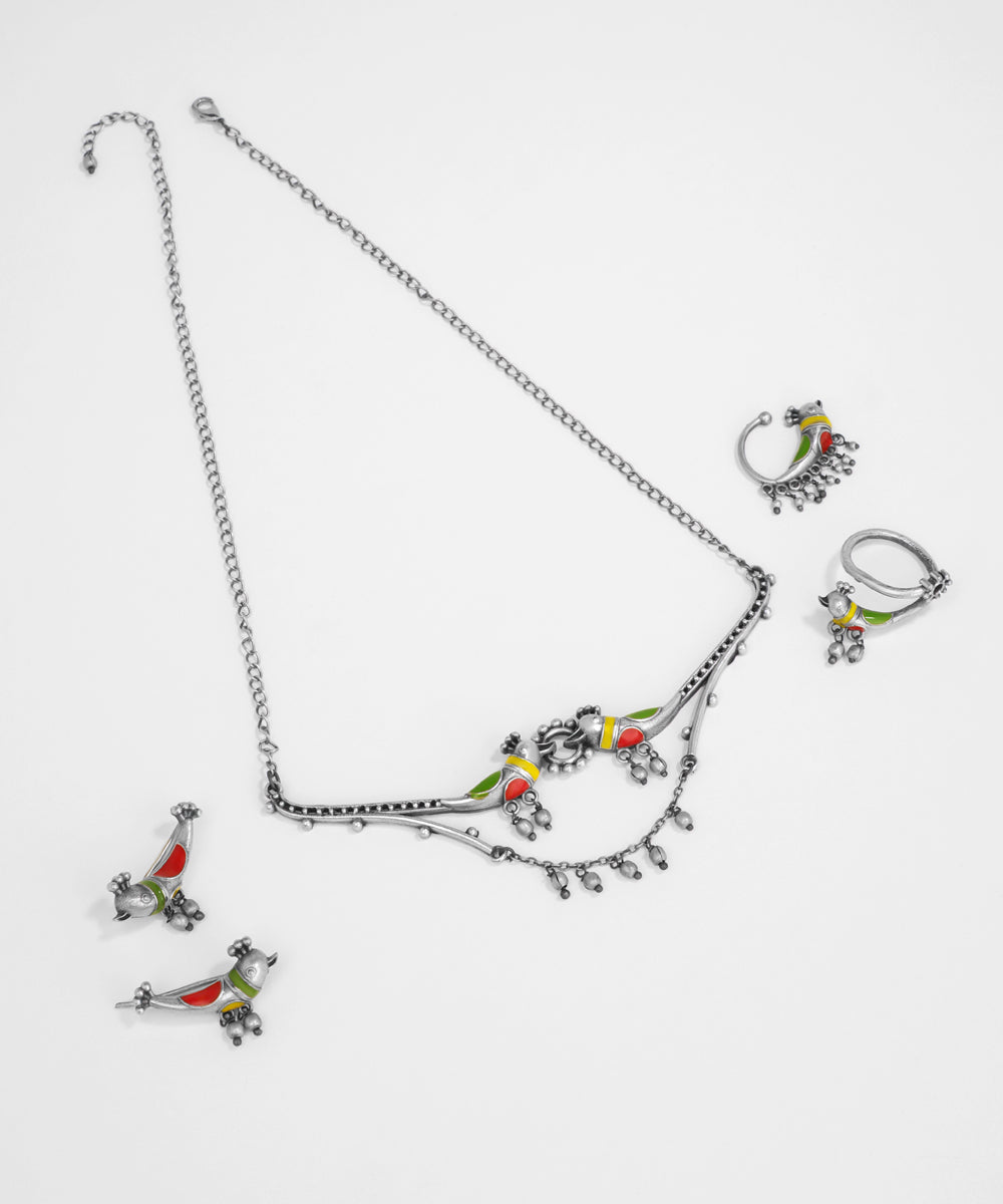 Silver necklace with colorful bird pendants on a white background